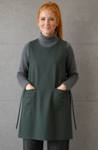 Mujer con delantal chinita verde antifluido antiácido con amarras laterales y dos bolsillos